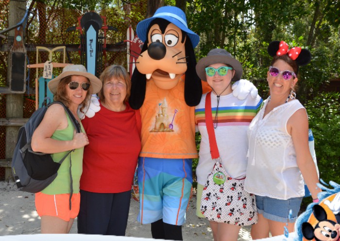 family with Goofy on vacation at Disney world