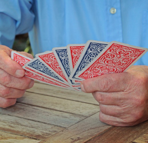 man holding playing cards