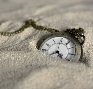 picture of roman numeral pocket watch in sand