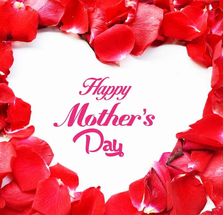 Flower petals in shape of heart with happy Mother's Day written in middle
